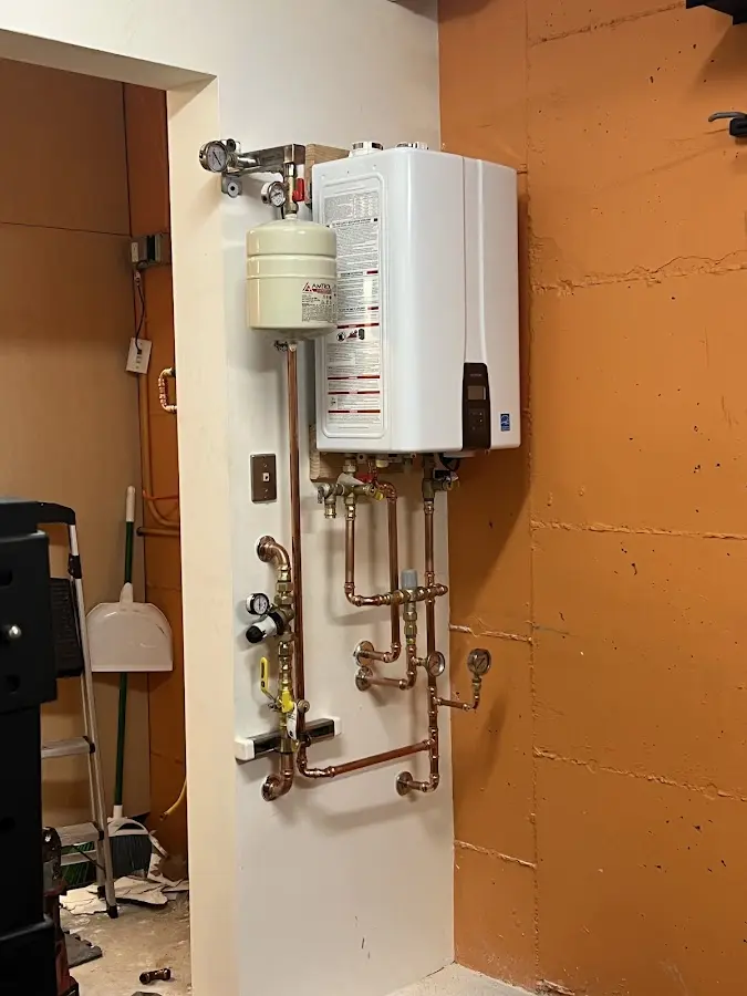 Plumbing technician inspecting water heater connections in Arlington Heights